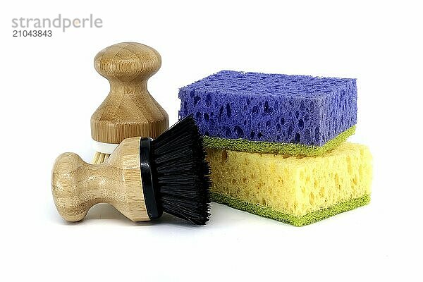 Sponges  each a different color purple  yellow and two brushes with wooden handles isolated on white background  cleaning tools