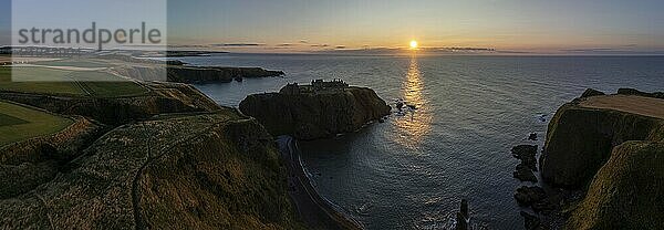 Dunnottar Castle  castle ruins at sunrise on the cliffs  drone shot  Stonehaven  Aberdeenshire  Scotland  Great Britain