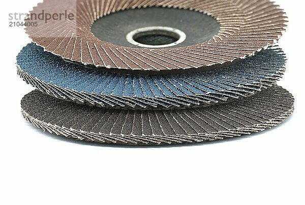 Several sanding discs in close-up view isolated on white background  typically used for grinding  sanding  and polishing in various industries