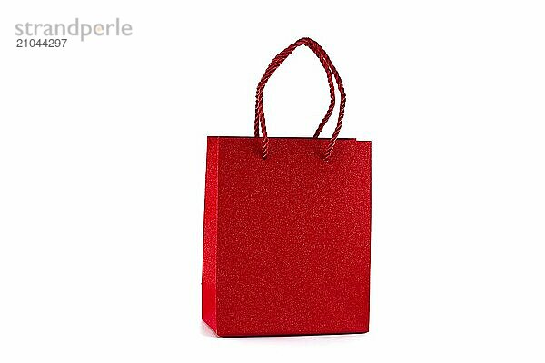 Red paper shopping bag isolated on white background. Gifts and shopping concept