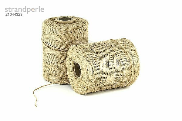 Pair of natural brown twisted jute twine spools isolated on white background