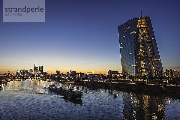 A ship sails past the European Central Bank (ECB) from the Frankfurt banking skyline  Frankfurt am Main  Hesse  Germany  Europe