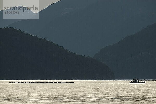 Ship pulling a raft through Howe Sound in British Columbia  Canada  North America