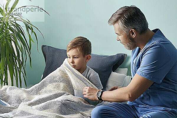 Father takes care of his sick son and puts a blanket over him  AI generated  AI generated