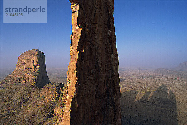 People rock climbing in Mali.