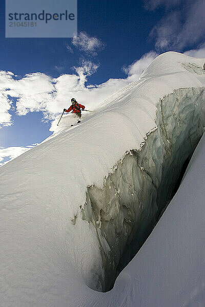 A young man skiing offpiste next to a big crevasse in Courmayeur  Valle d'Aosta  Italy.