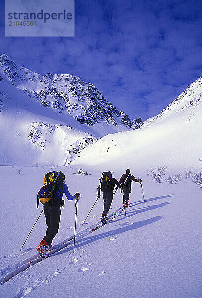 Two men and a woman ski tour and explore the mountains of the Lyngen Alps in Norway.