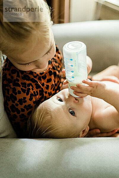 Toddler bonds with baby sister