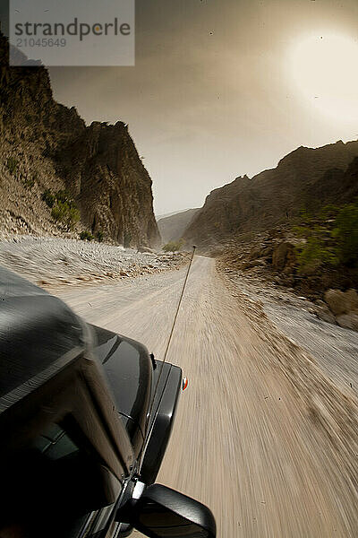 Jeep heading off-road through the rocky crags of Wadi Bih in Ras Al Khaimah  United Arab Emirates.