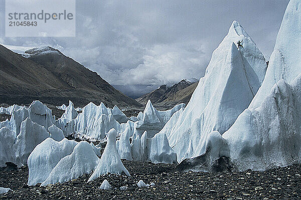 An ice climber climbs an ice tower on the Rongbuk Glacier  Tibet.