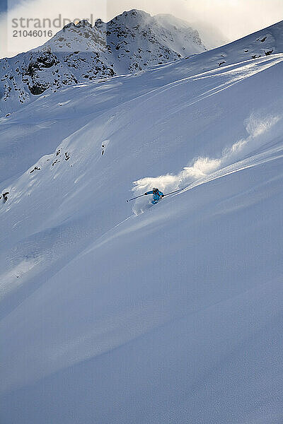 A young man skiing in powder snow in Champorcher  Valle d'Aosta  Italy.