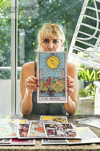 Seriöser Tarot Leser  der die riesige Tarotkarte Der Mond vorstellt