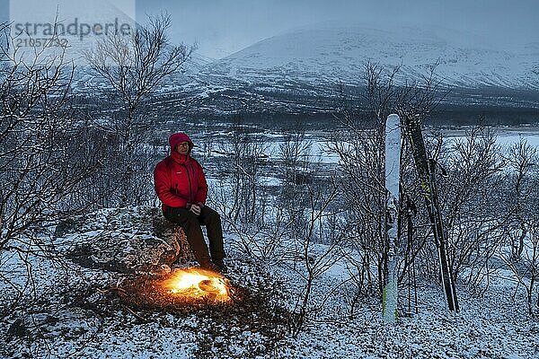 Mann am Lagerfeuer  Stora Sjöfallet Nationalpark  Welterbe Laponia  Norrbotten  Lappland  Schweden  April 2018  Lappland  Schweden  Europa