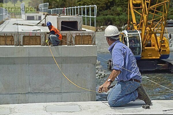 Bauarbeiter errichten eine Betonbrücke über einen kleinen Fluss in Westland  Neuseeland  Ozeanien