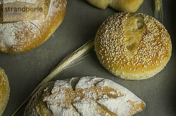 Schönes Sauerteigbrot auf grauem Hintergrund mit getrockneter Weizenblüte