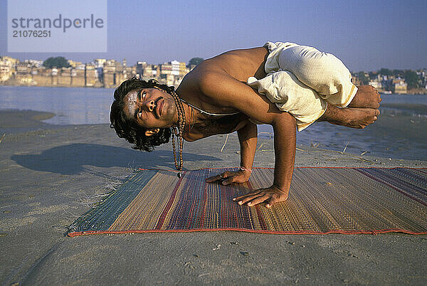 A Yogi Priest practices by Yoga near the Ganges River  Varanasi  Uttar Pradesh  India.