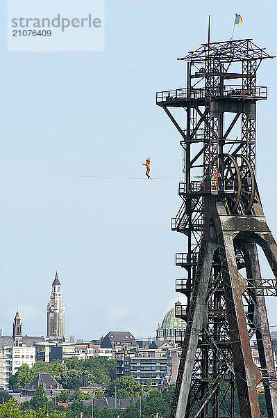 Slackliner walking on tightrope hanging on tower  Charleroi  Wallonia  Belgium