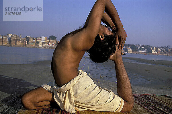 A Yogi Priest practices by Yoga near the Ganges River  Varanasi  Uttar Pradesh  India.