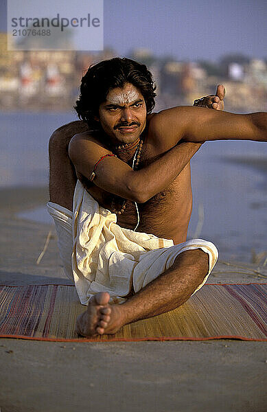 A Yogi Priest practices by Yoga near the Ganges River  Varanasi  Uttar Pradesh  India.