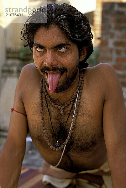 A Yogi Priest practices by Yoga near the Ganges River  Varanasi  Uttar Pradesh  India.