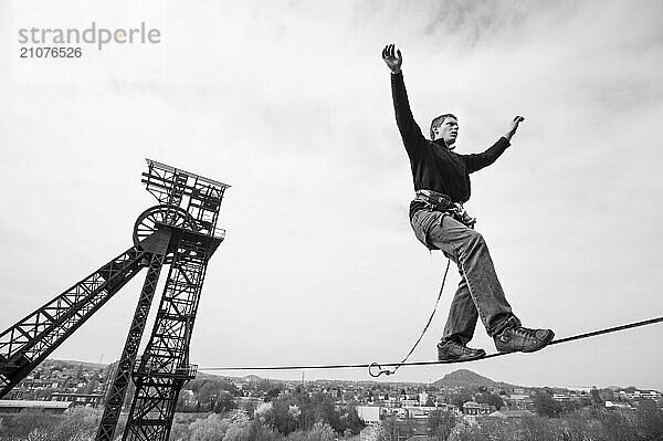 Highliner balancing on tightrope on mine shaft tower  Charleroi  Wallonia  Belgium