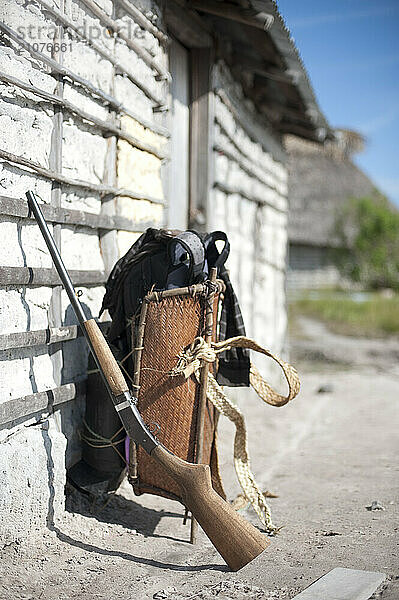 Gun And Backpack Near The Mud Wall In Venezuela