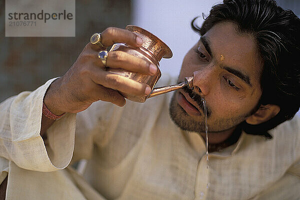 A Yogi Priest practices by Yoga near the Ganges River  Varanasi  Uttar Pradesh  India.