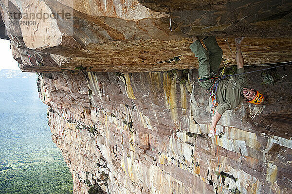 Man climbing rock ceiling at Apichavai