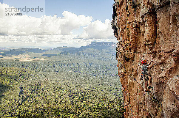 Man climbing steep cliff at Apichavai