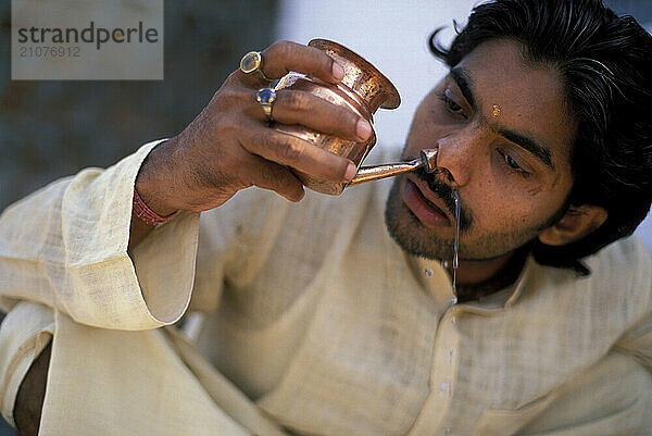 A Yogi Priest practices by Yoga near the Ganges River  Varanasi  Uttar Pradesh  India.