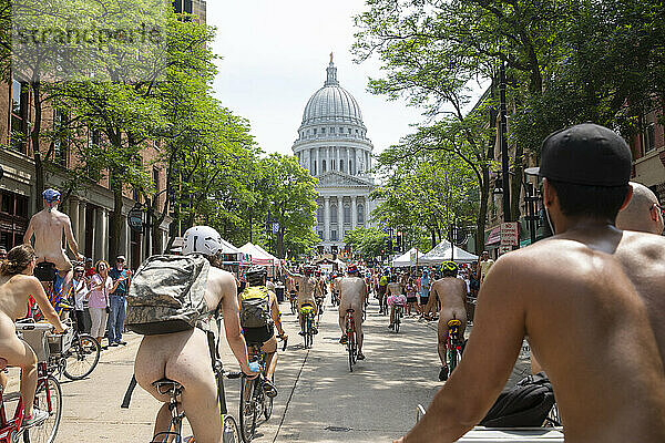 Large number of naked cyclists riding toward state capitol to protest dependence on fossil fuels  Madison  Wisconsin  USA