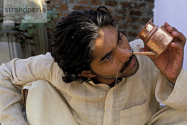 A Yogi Priest practices by Yoga near the Ganges River  Varanasi  Uttar Pradesh  India.