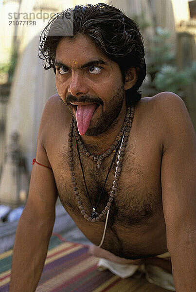 A Yogi Priest practices by Yoga near the Ganges River  Varanasi  Uttar Pradesh  India.