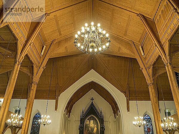 Church interior with wooden ceiling and large chandeliers  kristiansand  norway