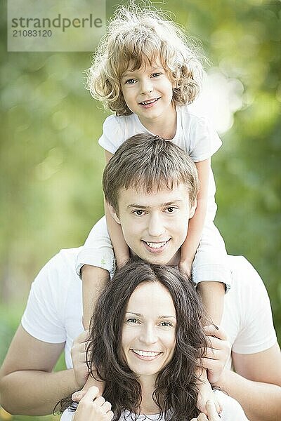 Glückliche Familie mit Spaß im Freien gegen Frühling grünen Hintergrund