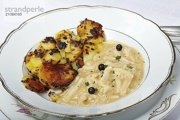 Schwäbische Küche  Saure Kutteln mit Röstkartoffeln  Kartoffelrädchen angebraten  Fleischgericht  Innereien  deftig  salzig  typisch Schwäbisch  Hausmannskost  Traditionsküche  Wacholder  Suppenteller  Foodfotografie  Studio  Deutschland  Europa