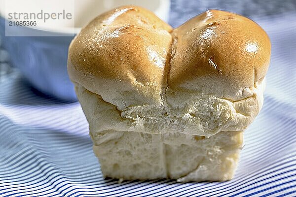 Mini Butter Brioche mit Kaffeebecher auf hellblauem Hintergrund