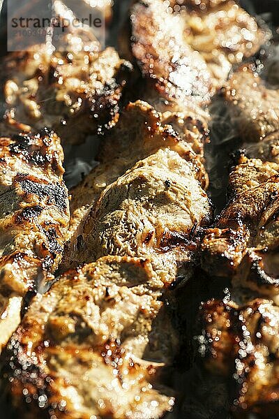 Grilled meat on barbecue. Shallow depth of field