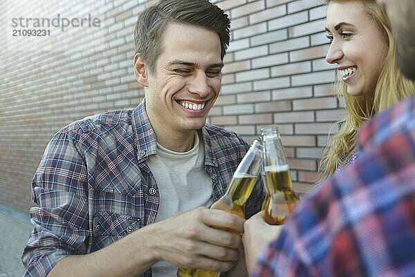 Group of young best friends having fun with beer at street