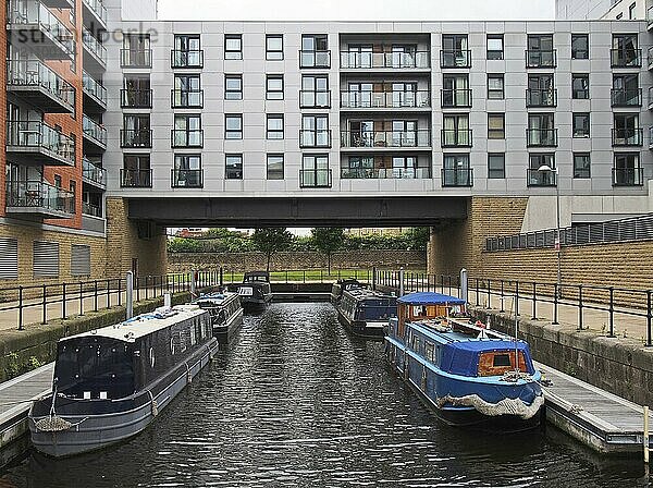 Leeds  west yorkshire  united kingdom  14 july 2019: houseboats moored between at modern buildings at leeds dock