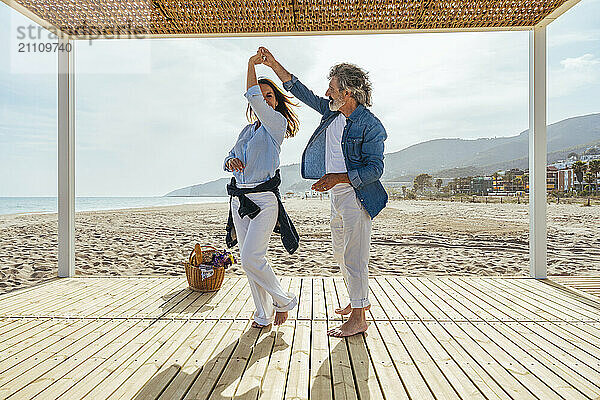 Happy senior couple dating at the beach