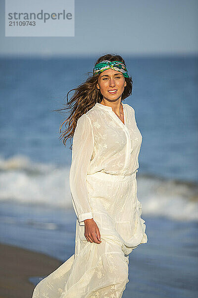 Smiling woman standing at beach