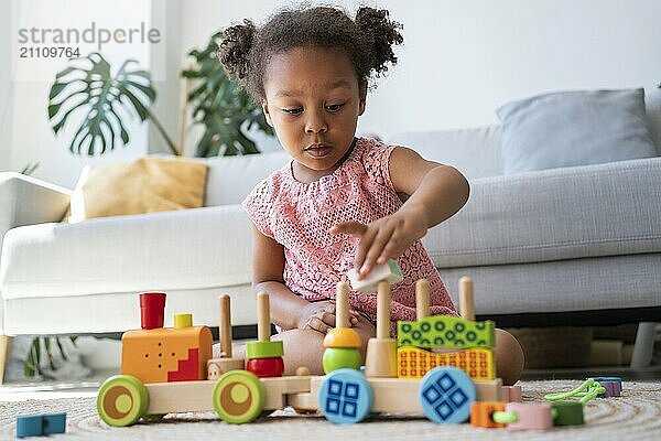 Girl stacking toys at home