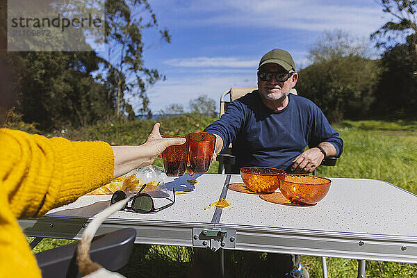 Senior couple doing celebratory toast during vacations on mountain