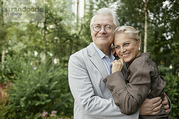 Smiling couple embracing at park