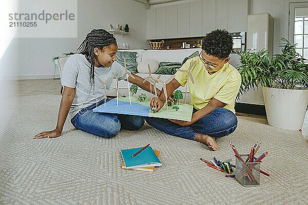 Siblings making solar energy project at home