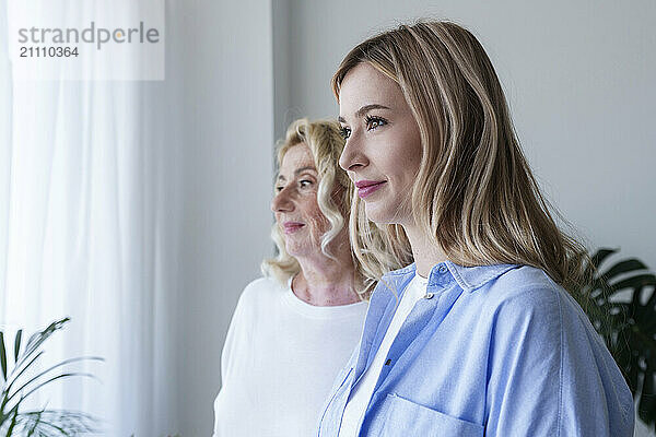 Smiling mother and daughter at home