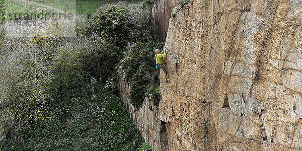 Man climbing on North Berwick Law in Scotland