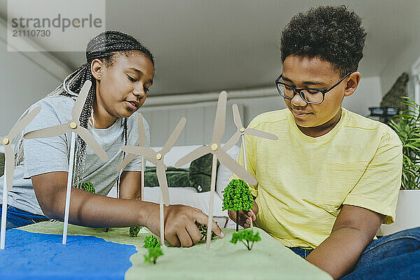 Brother and sister making solar energy project at home