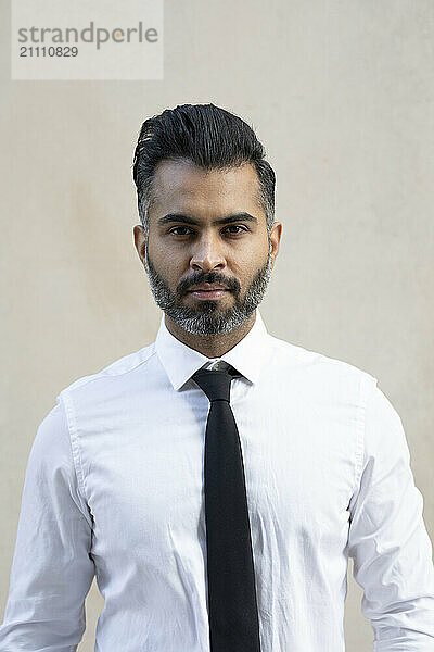 Businessman in smart casual against beige background